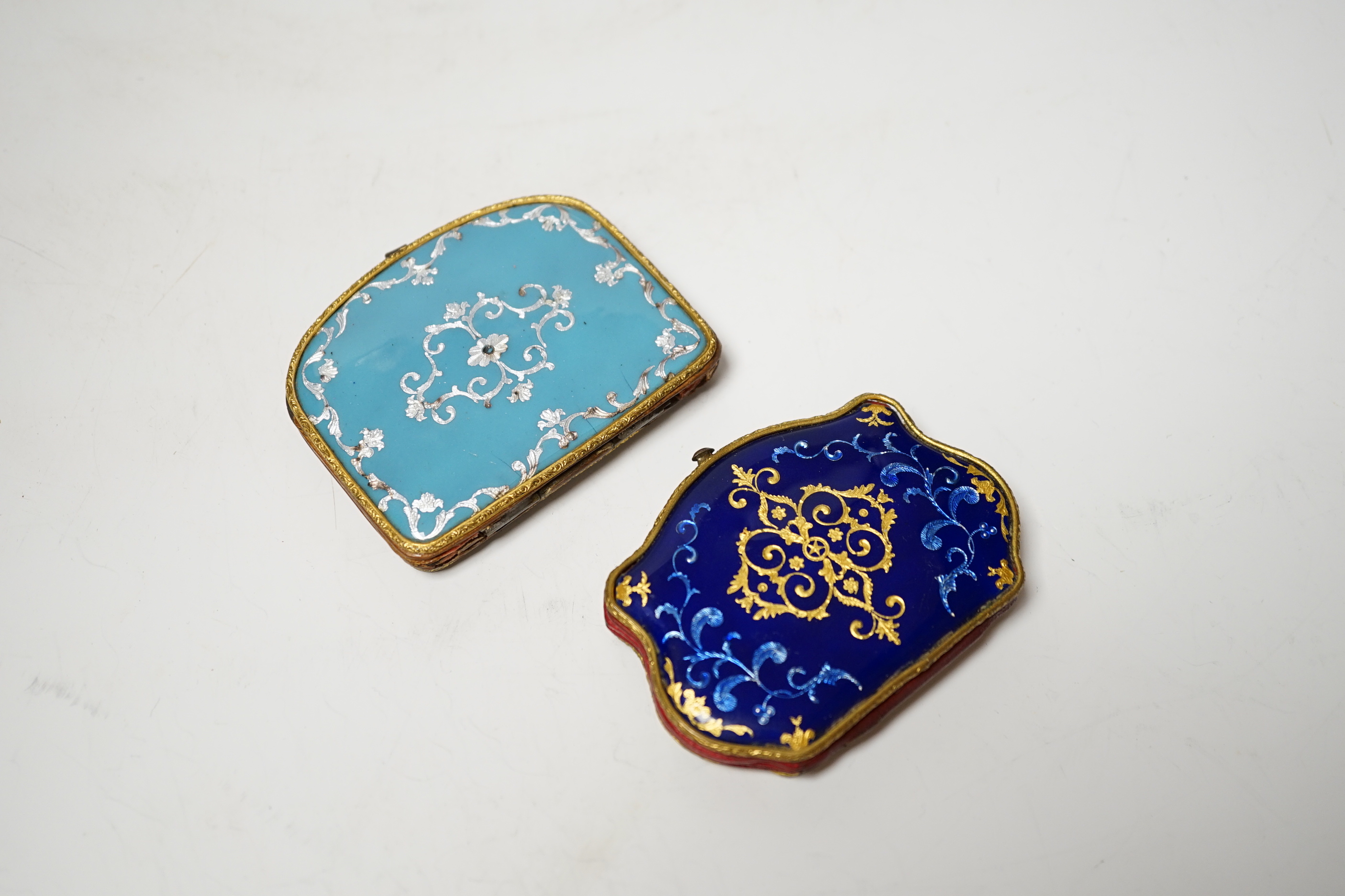 Two 19th century French or Swiss enamelled purses, One finely painted with a spaniel seated on a cushion, the other with a bouquet of flowers